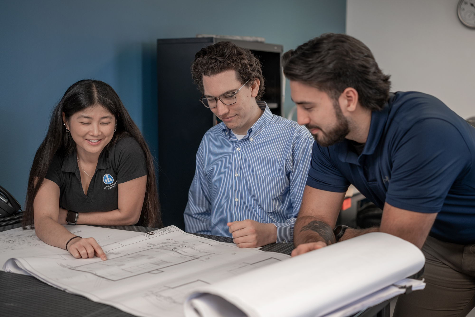 Three Engineers discussing blueprints